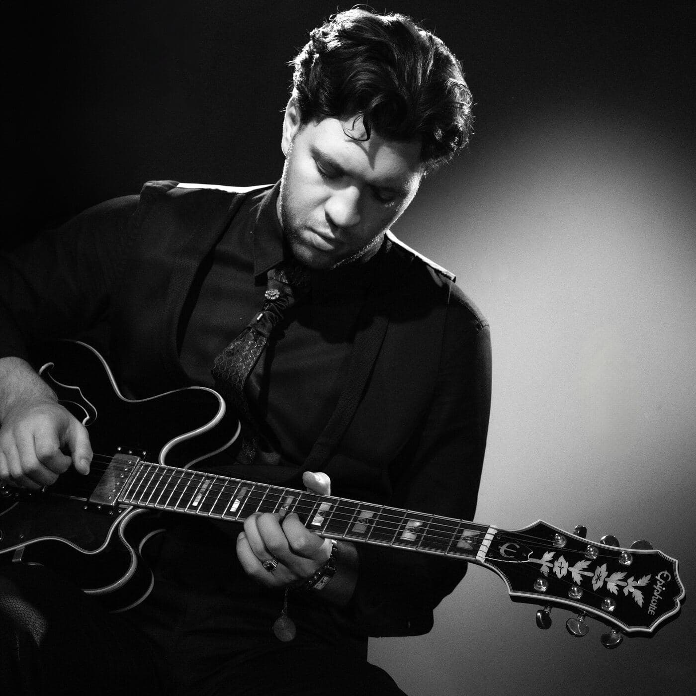 Marcel Gorlami playing guitar during a live performance